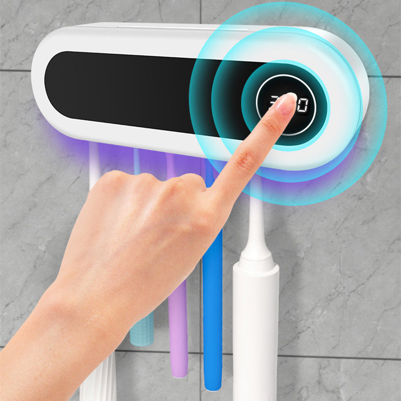 Support à brosses à dents mural avec distributeur de dentifrice dans une salle de bain
